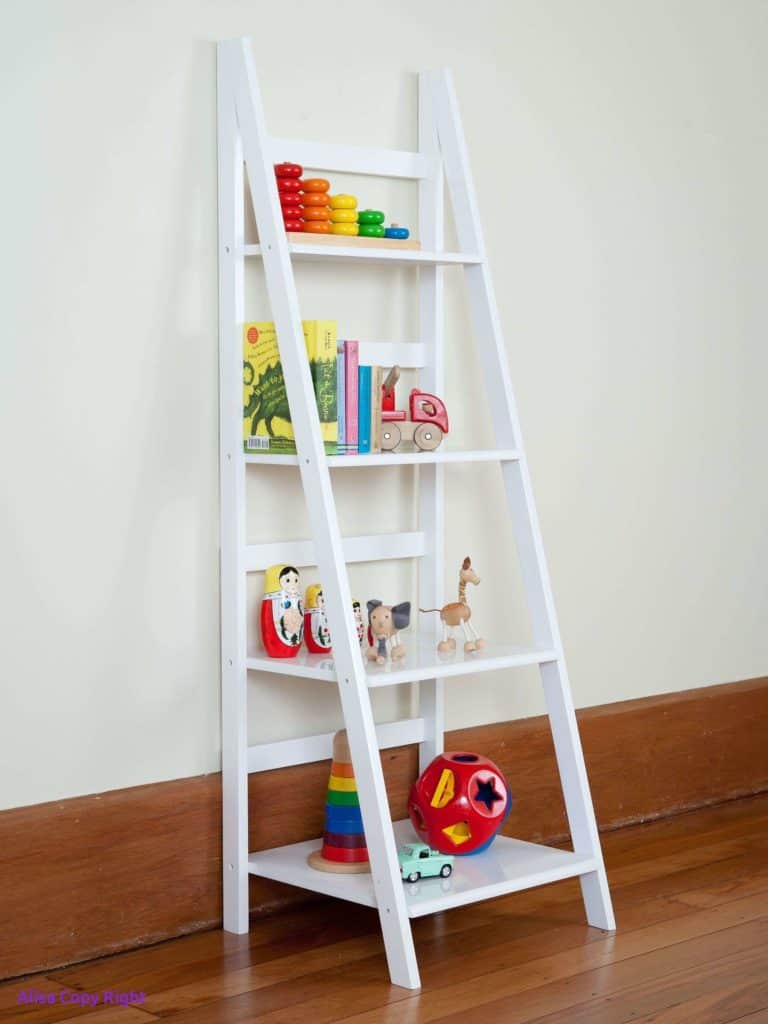 white decorative ladder used for toy storage