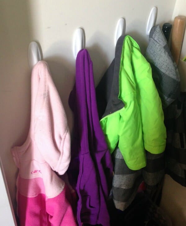 organized coats hung on back wall of closet